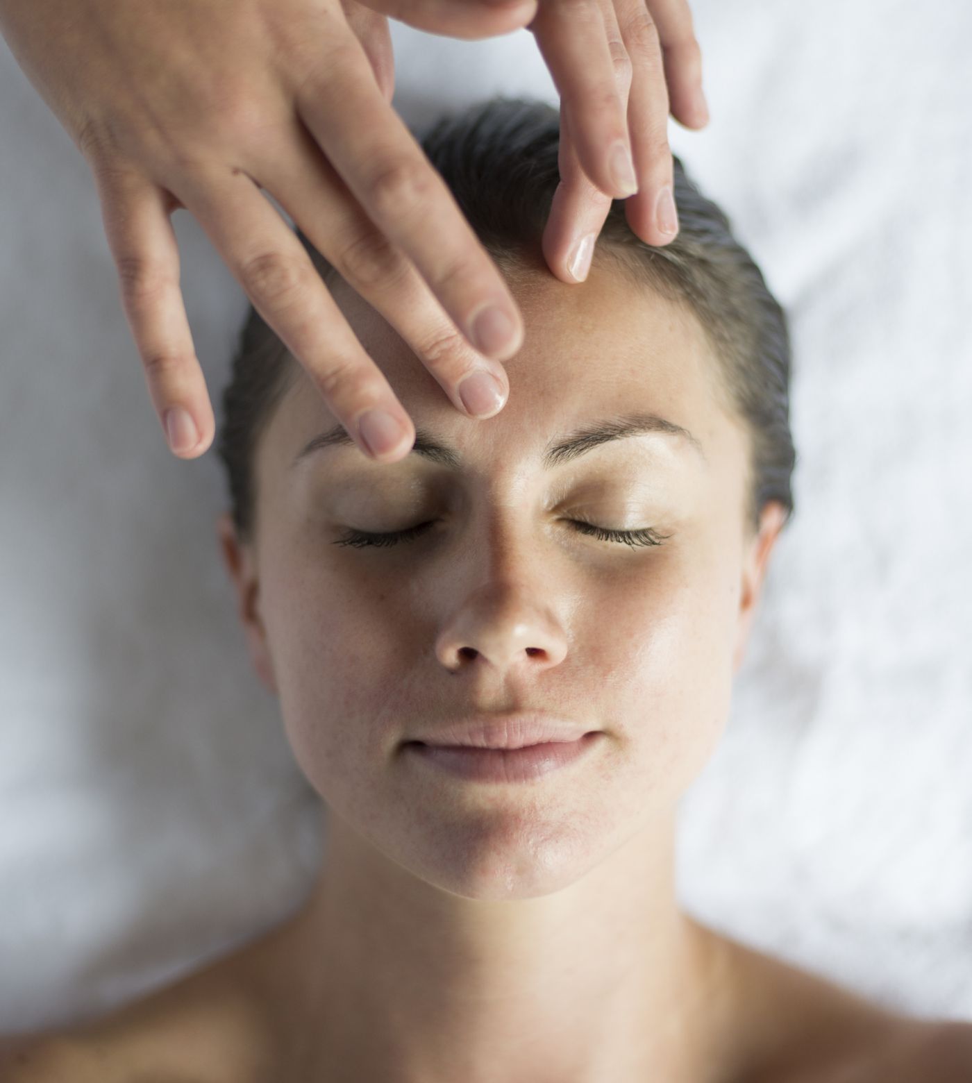 Woman receiving massage on forehead 